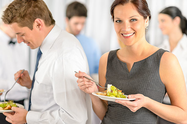 limonzest120500381.jpg - smiling business woman during company lunch buffet hold salad plate